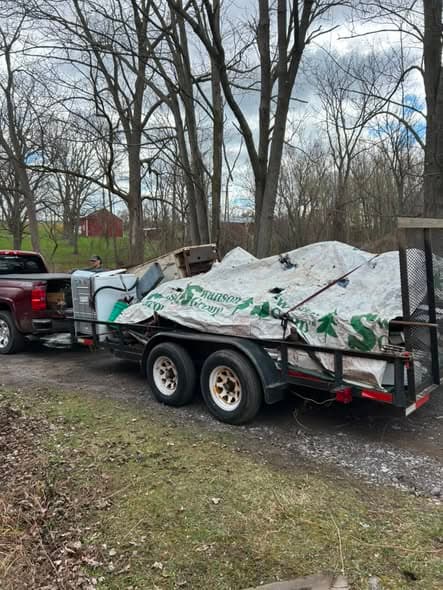 Trailer loaded with a pool liner and bulky construction debris